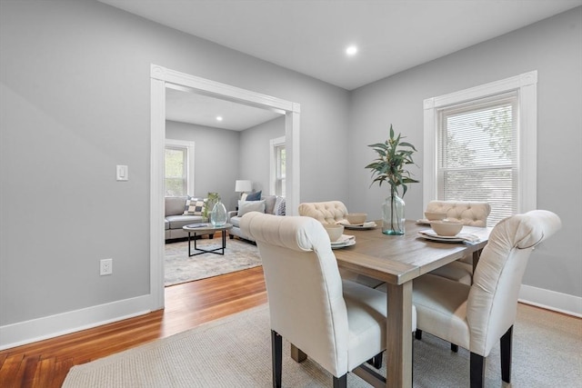 dining space with wood finished floors, baseboards, and recessed lighting