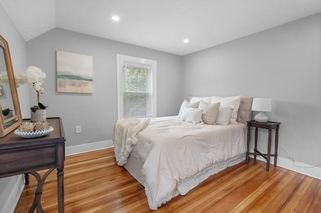 bedroom with light wood-type flooring, baseboards, lofted ceiling, and recessed lighting