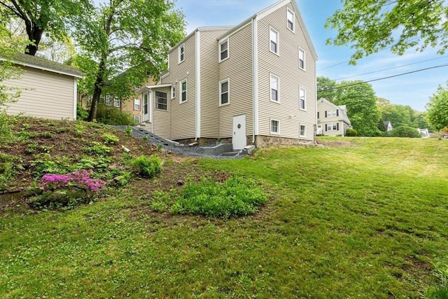 rear view of property with a lawn