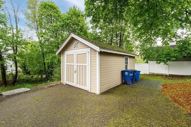 view of shed with fence