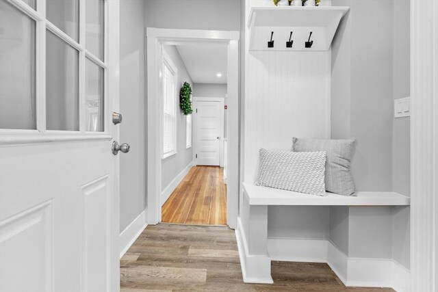 mudroom with wood finished floors and baseboards