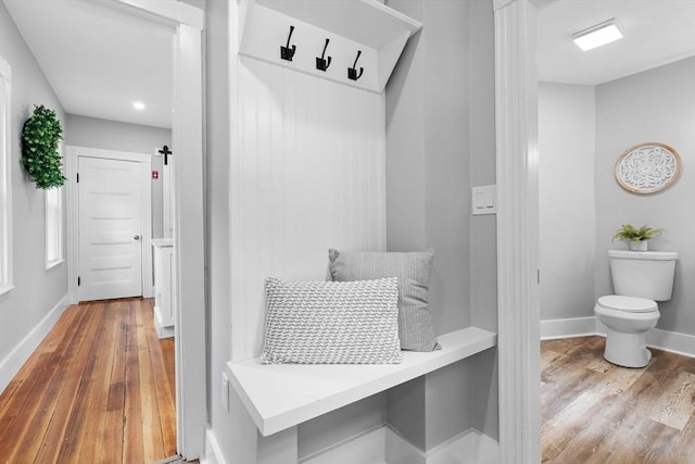 mudroom with wood finished floors and baseboards