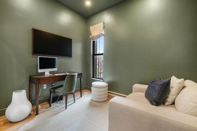 home office with a baseboard heating unit, wood finished floors, baseboards, and recessed lighting