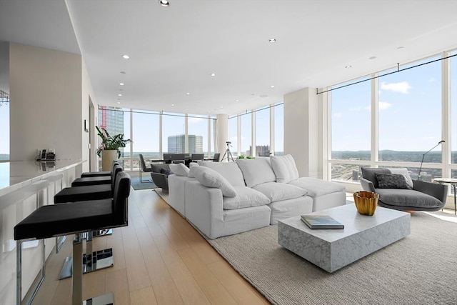 living room with expansive windows and light wood-type flooring