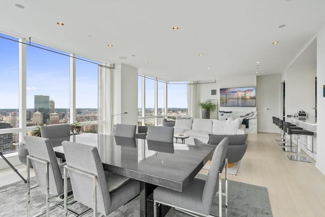 dining area with light hardwood / wood-style flooring and floor to ceiling windows