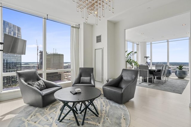 sitting room with a notable chandelier and light hardwood / wood-style flooring