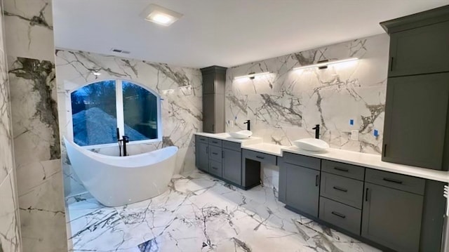 bathroom featuring vanity, tile walls, and a washtub