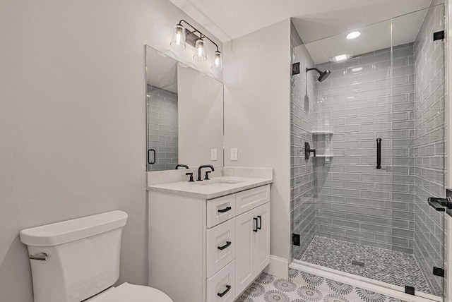 full bath featuring vanity, tile patterned floors, toilet, and a stall shower