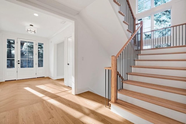 foyer entrance with crown molding, stairway, recessed lighting, and baseboards