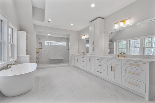 full bathroom with double vanity, a wealth of natural light, marble finish floor, and a marble finish shower