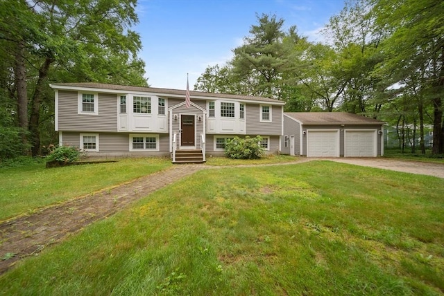 80 E St, Pepperell, MA 01463 - raised ranch featuring concrete driveway, a front lawn, and an attached garage