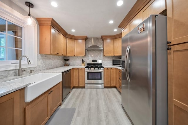 80 E St, Pepperell, MA 01463 - kitchen with stainless steel appliances, wall chimney range hood, light wood-style floors, backsplash, and light stone counters