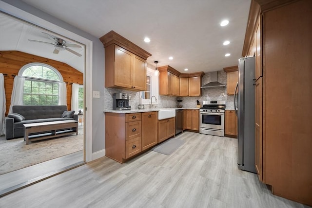 80 E St, Pepperell, MA 01463 - kitchen featuring stainless steel appliances, wall chimney range hood, light wood-style floors, brown cabinetry, and lofted ceiling