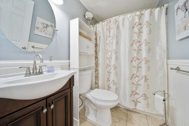 80 E St, Pepperell, MA 01463 - full bathroom with vanity, a wainscoted wall, tile patterned flooring, and a shower with shower curtain