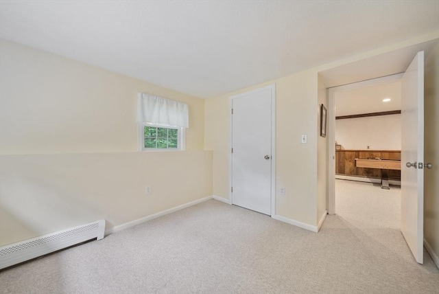 80 E St, Pepperell, MA 01463 - unfurnished bedroom with a baseboard radiator and light carpet