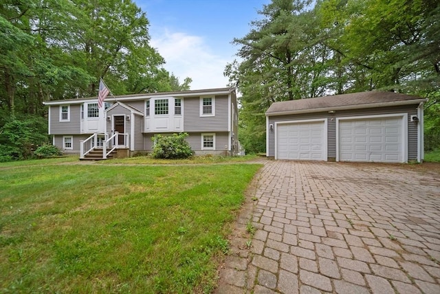 80 E St, Pepperell, MA 01463 - raised ranch with a detached garage, a front lawn, and an outbuilding