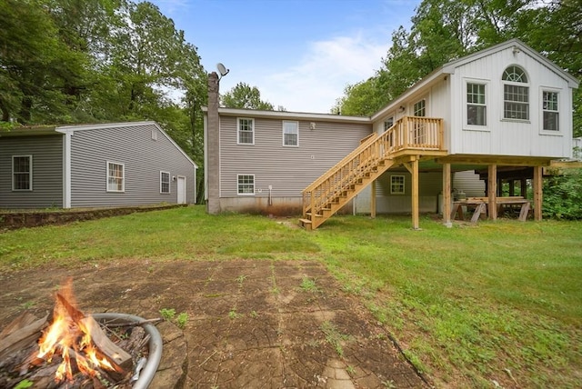 80 E St, Pepperell, MA 01463 - back of property featuring stairs, a yard, a deck, a chimney, and a fire pit