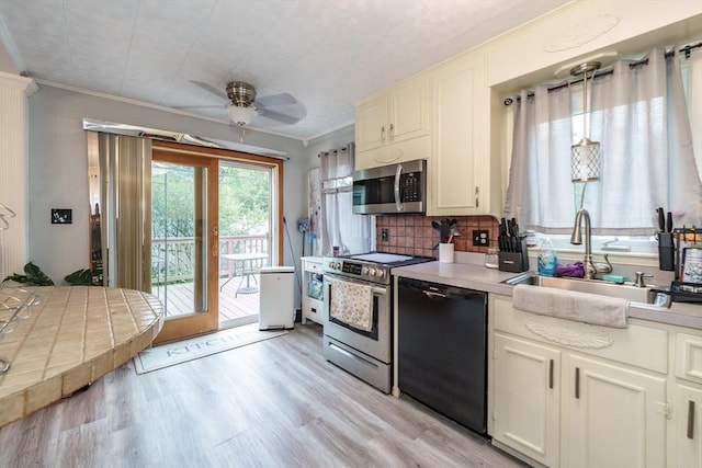 276 Oak St, Springfield, MA 01151 - kitchen with appliances with stainless steel finishes, crown molding, ceiling fan, a sink, and light countertops
