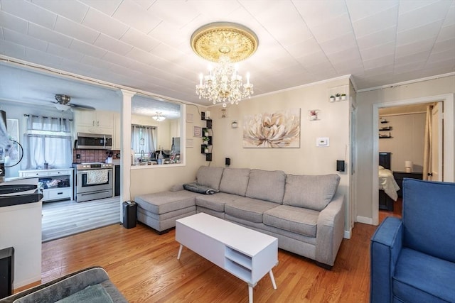 276 Oak St, Springfield, MA 01151 - living room featuring ornamental molding, a chandelier, and light wood-style floors