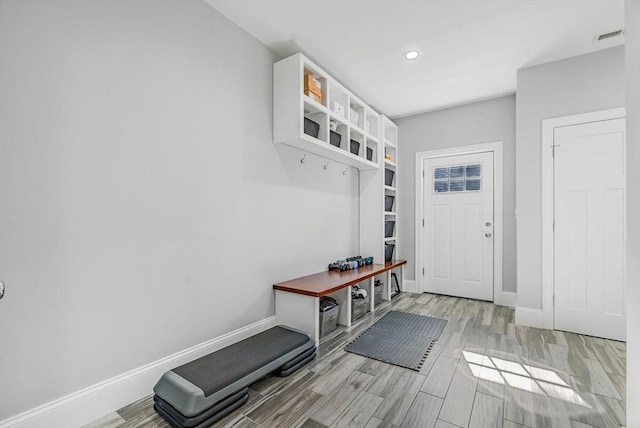 mudroom featuring wood tiled floor, visible vents, baseboards, and recessed lighting