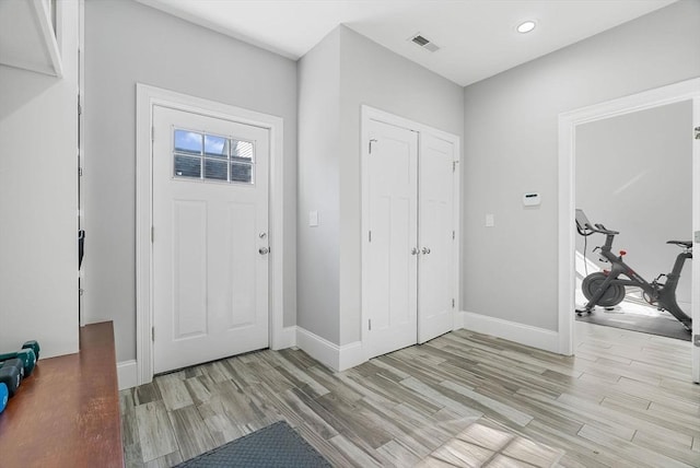 entrance foyer featuring visible vents, light wood-style flooring, and baseboards