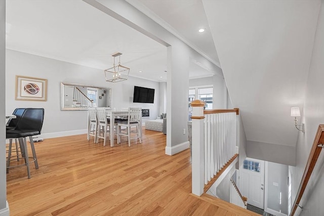 dining area featuring a chandelier, light wood-style flooring, recessed lighting, baseboards, and crown molding