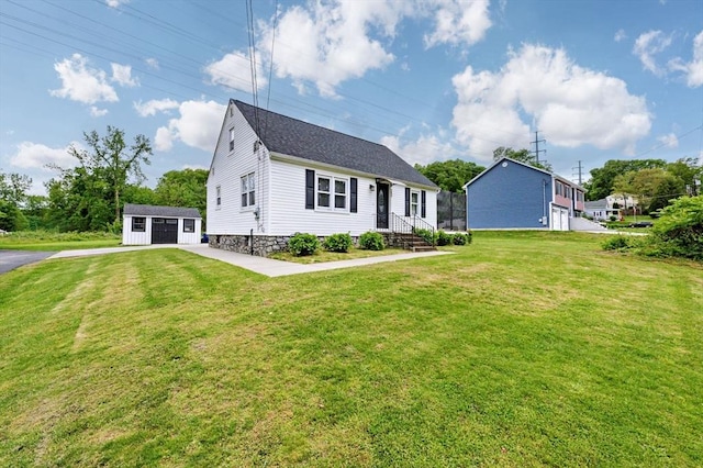 151 Labelle St, West Springfield, MA 01089 - view of front of house with a front lawn, a garage, an outdoor structure, and a shingled roof