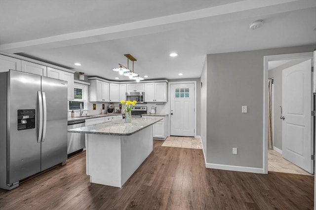 151 Labelle St, West Springfield, MA 01089 - kitchen with stainless steel appliances, dark wood finished floors, light stone countertops, recessed lighting, and a kitchen island