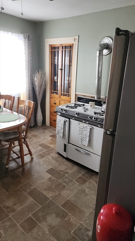 kitchen featuring stainless steel fridge and white gas range oven