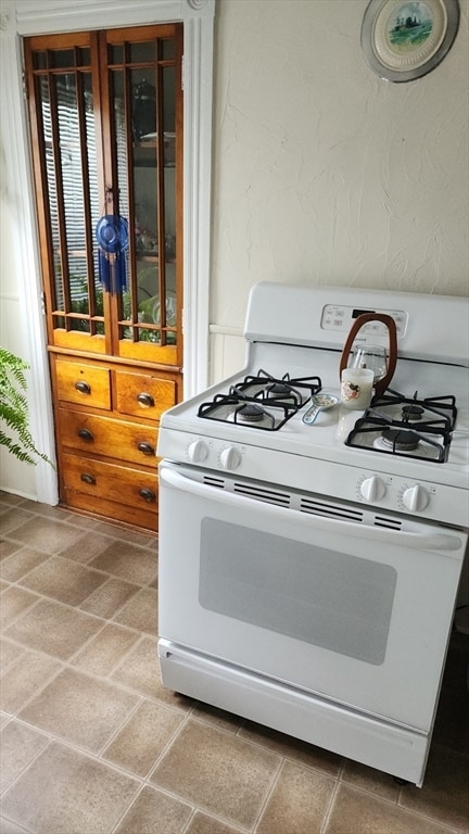 kitchen featuring white range with gas cooktop