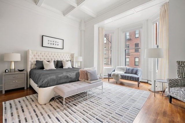 bedroom with coffered ceiling, beam ceiling, light wood-type flooring, and multiple windows