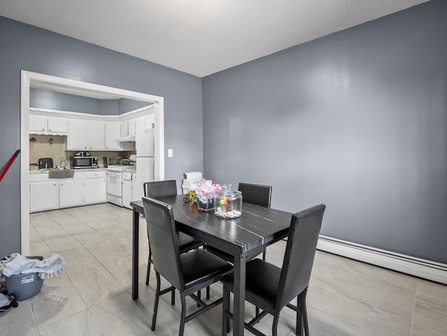 dining room featuring baseboard heating and a textured ceiling