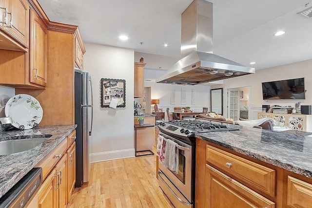 110 O St Unit 1, Boston, MA 02127 - kitchen with dark stone countertops, island range hood, open floor plan, light wood-style floors, and appliances with stainless steel finishes