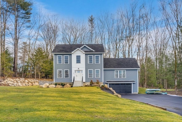 view of front of home featuring a garage and a front lawn