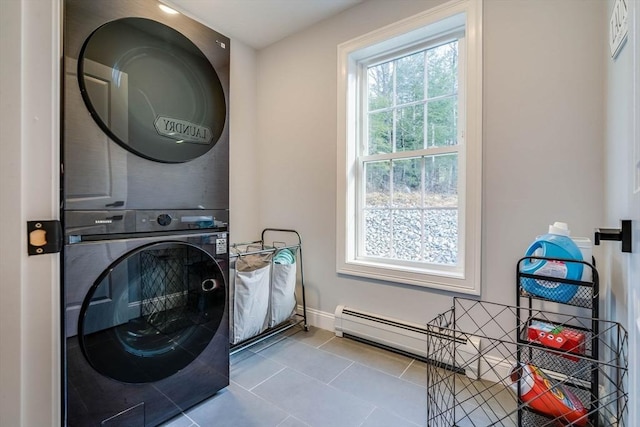 washroom featuring light tile patterned floors and stacked washer and clothes dryer