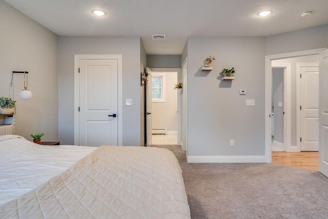 bedroom featuring light colored carpet and a baseboard radiator