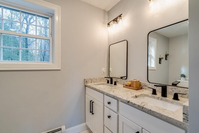 bathroom with vanity and a baseboard heating unit