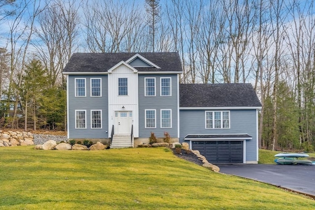 view of front of house with a garage and a front yard