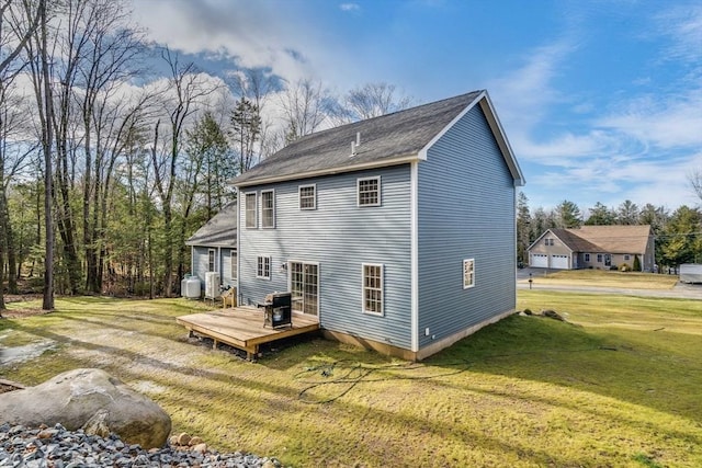 back of house featuring a deck and a yard