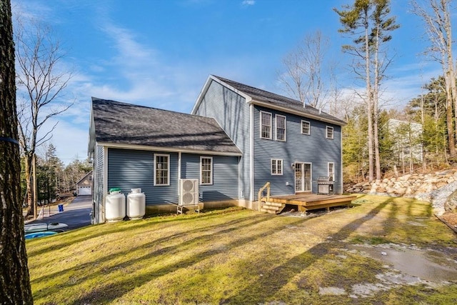 rear view of house featuring a lawn and a wooden deck