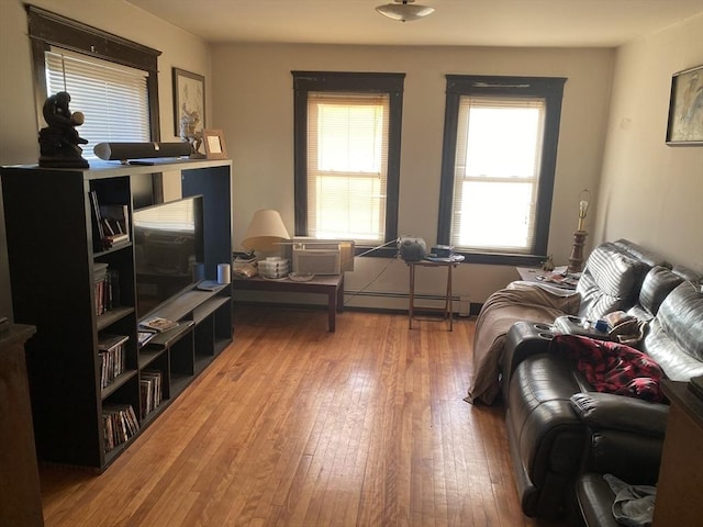 living room with a baseboard radiator and wood-type flooring