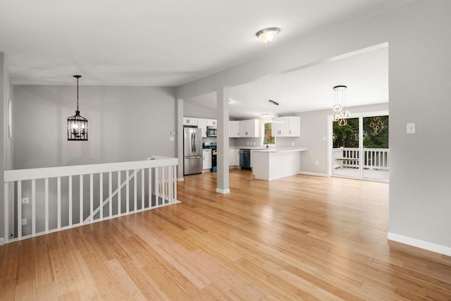 29 Hudson Ave, Southbridge, MA 01550 - unfurnished living room featuring a chandelier, light wood-style flooring, and baseboards