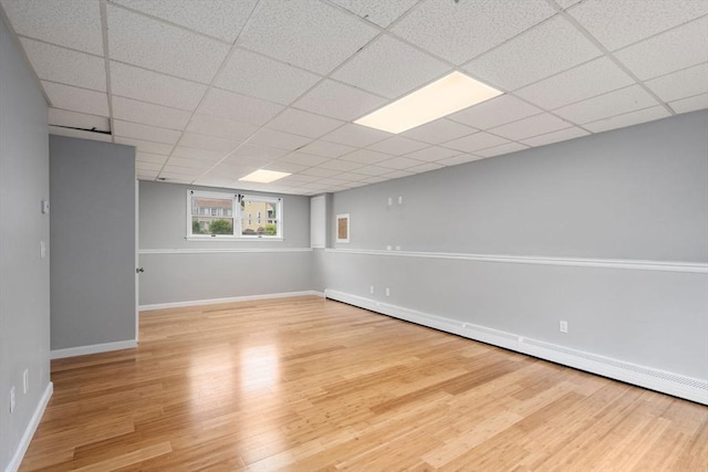29 Hudson Ave, Southbridge, MA 01550 - spare room with baseboard heating, wood finished floors, baseboards, and a drop ceiling