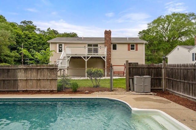 29 Hudson Ave, Southbridge, MA 01550 - back of property with a fenced backyard, a chimney, stairway, and a deck