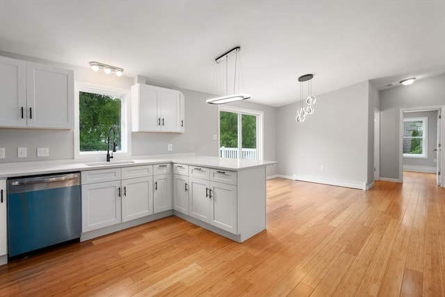 29 Hudson Ave, Southbridge, MA 01550 - kitchen featuring dishwasher, a sink, a peninsula, and light countertops