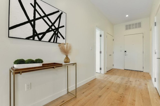 hallway with light hardwood / wood-style flooring