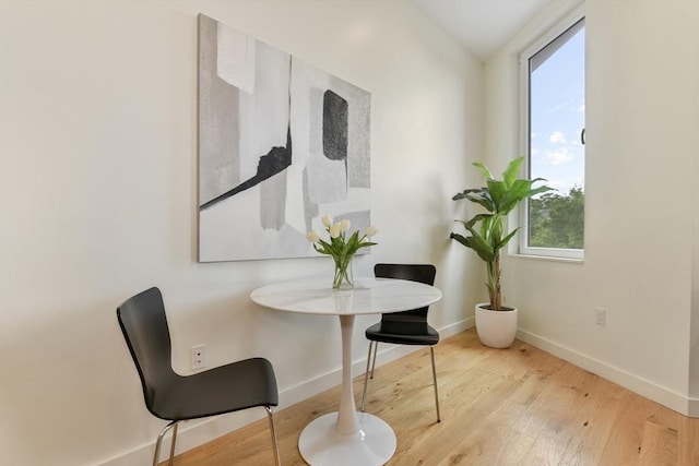 living area featuring vaulted ceiling and wood-type flooring