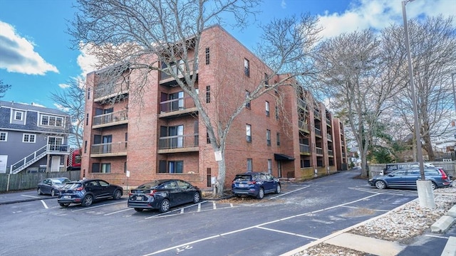 view of building exterior featuring uncovered parking