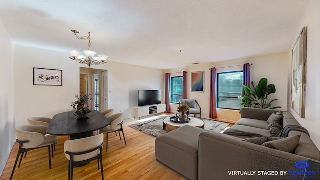 living area featuring an inviting chandelier and light wood-style flooring