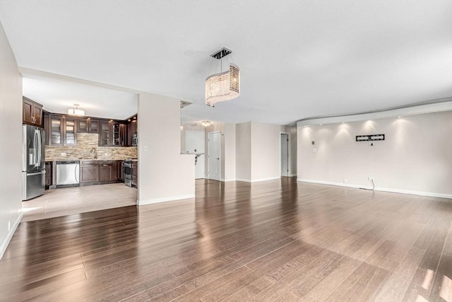 280 Boylston St Unit 511, Newton, MA 02467 - unfurnished living room with light wood finished floors, a sink, and baseboards